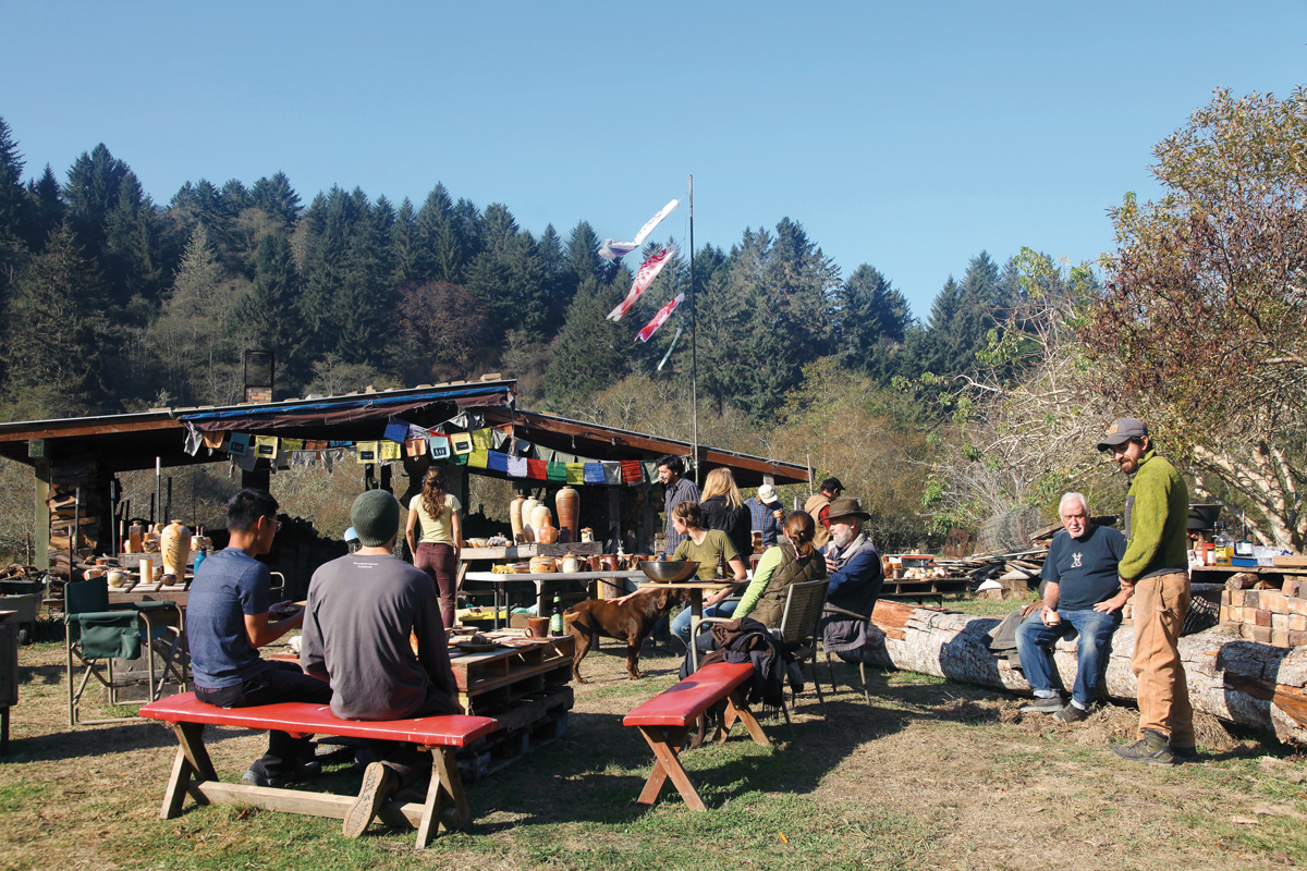 people sit at picnic tables and gather for food