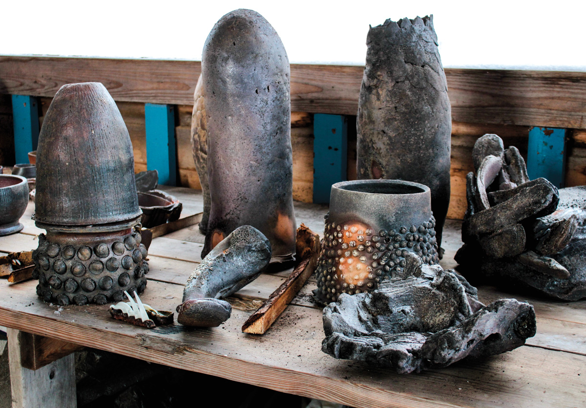 multiple ceramic pieces displayed on a wooden table