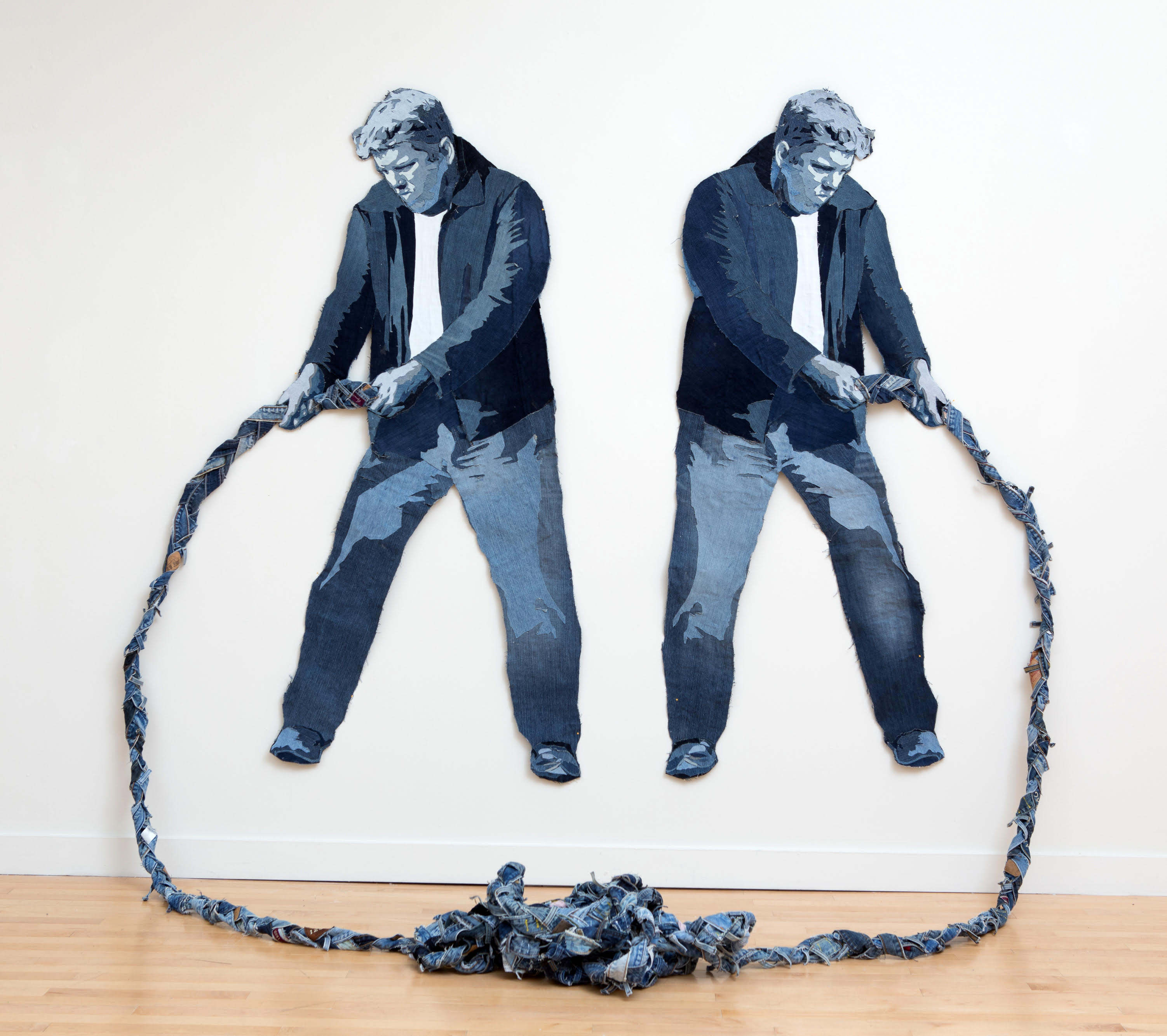 Textile installation featuring two men and knotted rope