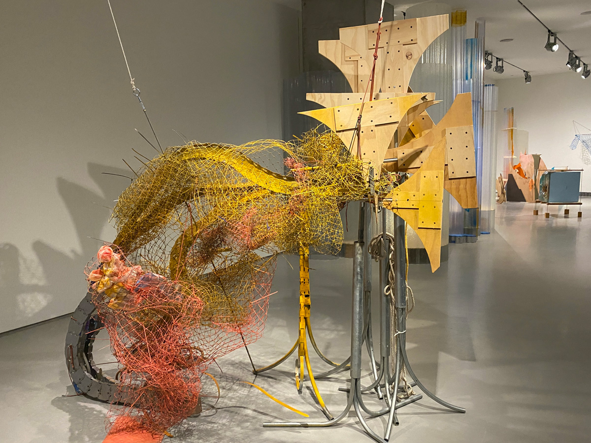 Installation view of sculpture with mesh and wood panels