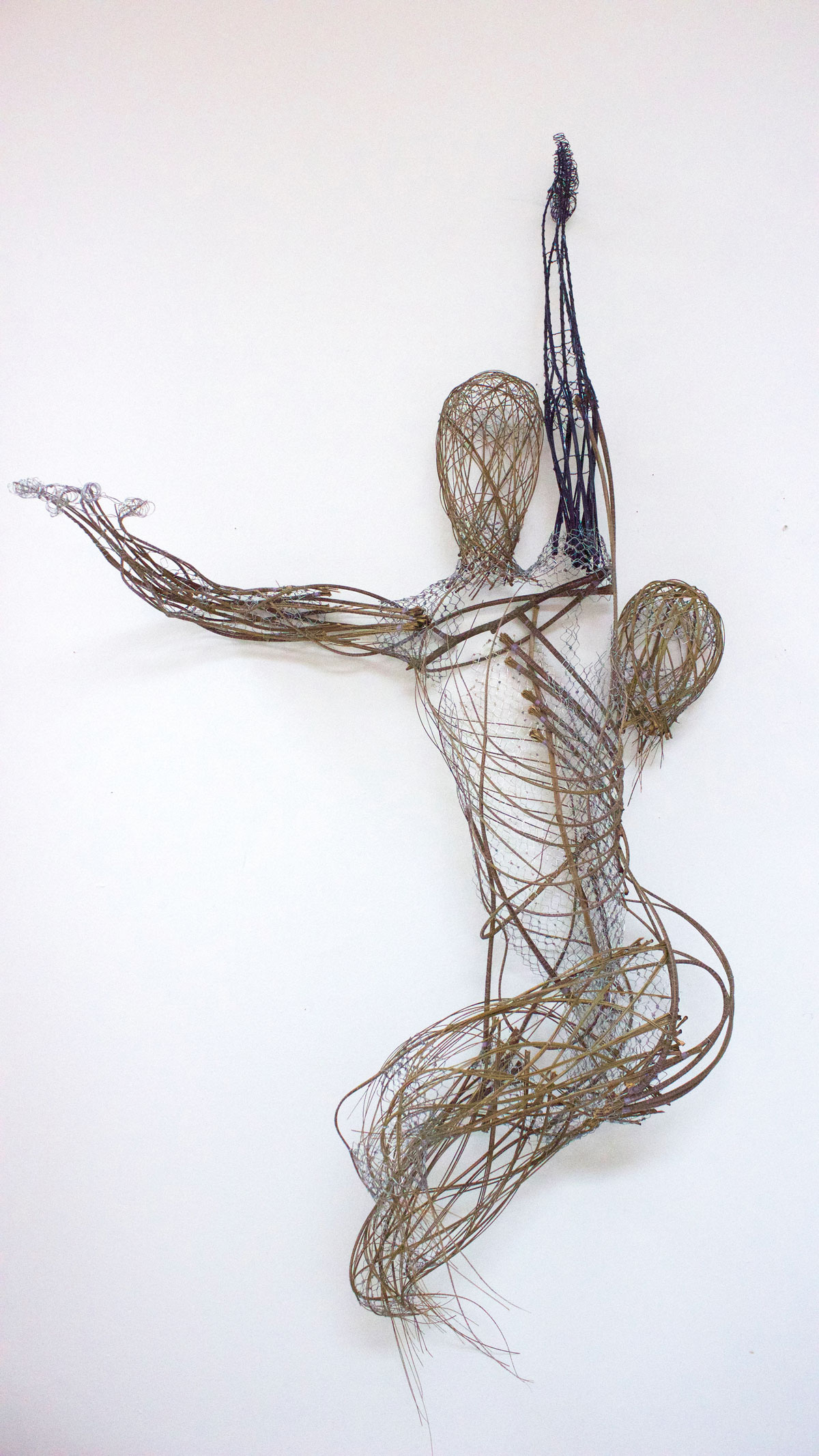palm spines weaved together into a human-esque figure
