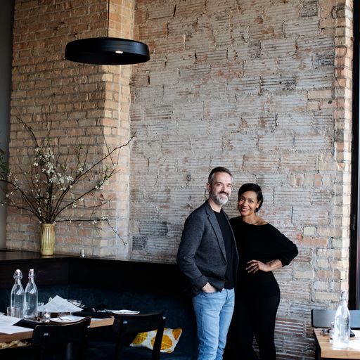 Couple posing in a hotel resaurant with brick walls