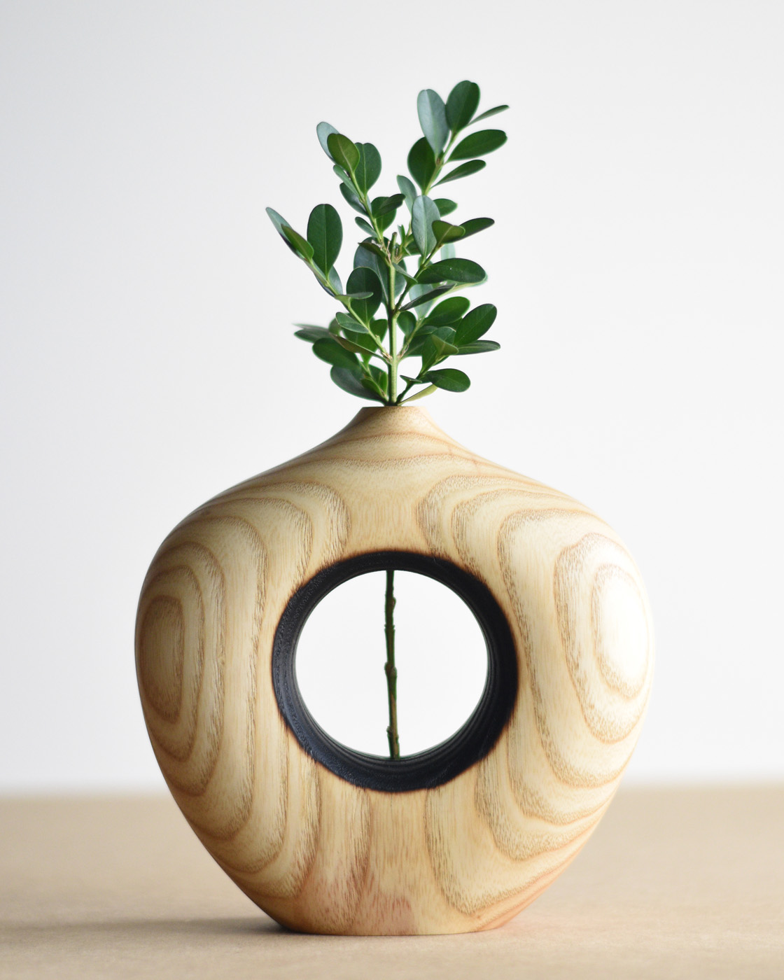 wood bud vase with green leaves